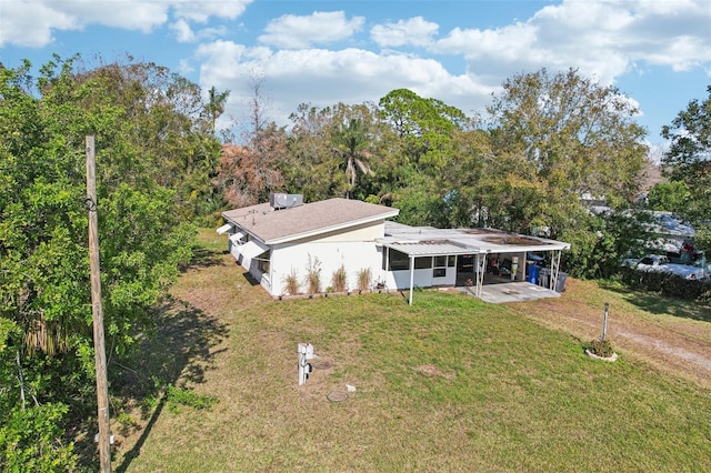 exterior space with a front lawn and a carport