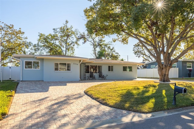 ranch-style home with a front lawn