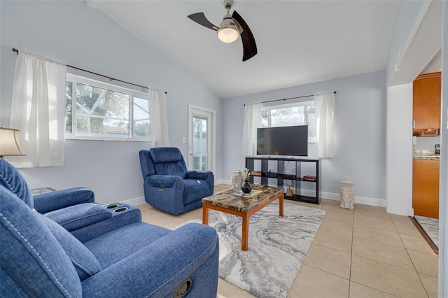 living room featuring ceiling fan, light tile patterned floors, and vaulted ceiling