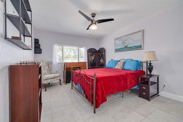 bedroom with light tile patterned floors, a textured ceiling, and ceiling fan