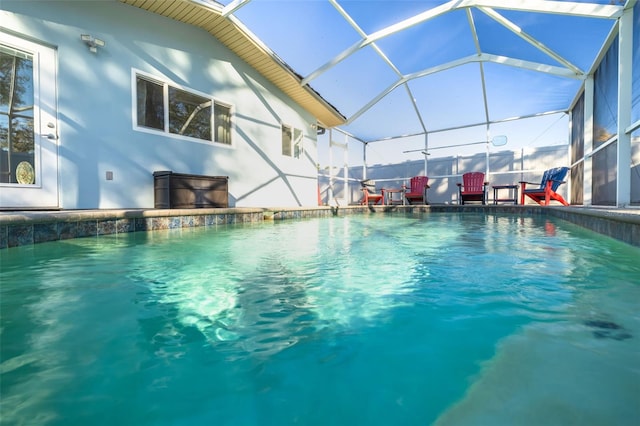 view of swimming pool with a lanai