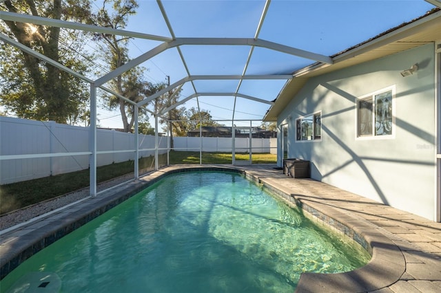 view of pool featuring glass enclosure