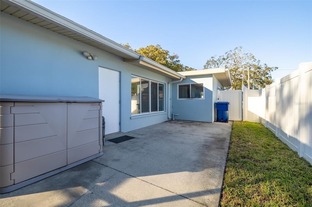 view of property exterior with a patio area