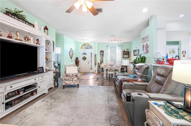 living room with dark hardwood / wood-style floors and ceiling fan