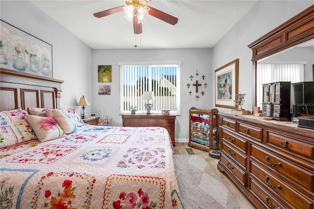 bedroom with ceiling fan and light hardwood / wood-style flooring