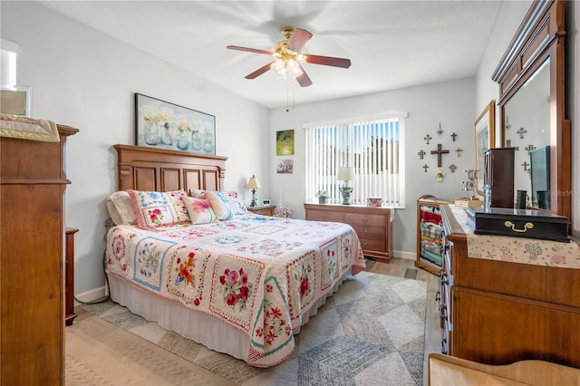 bedroom with ceiling fan and light hardwood / wood-style flooring