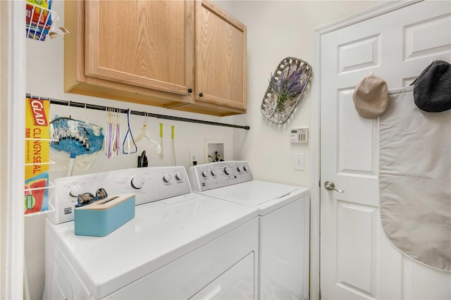 laundry room with cabinets and washer and dryer