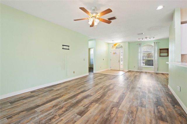 5215 New Brittany Ln, Zephyrhills, FL 33541 - empty room featuring wood finished floors, ceiling fan, baseboards, and recessed lighting