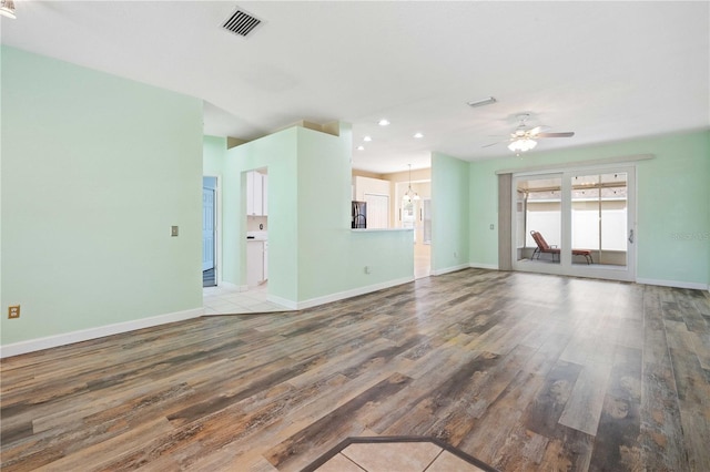 5215 New Brittany Ln, Zephyrhills, FL 33541 - unfurnished living room featuring wood finished floors, ceiling fan, baseboards, and recessed lighting