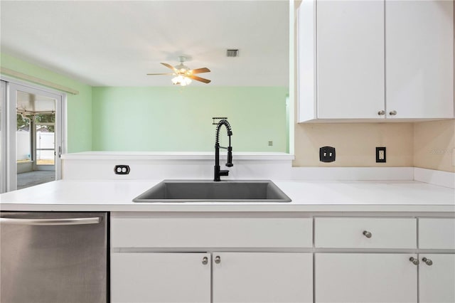 5215 New Brittany Ln, Zephyrhills, FL 33541 - kitchen with dishwasher, a sink, white cabinets, and light countertops