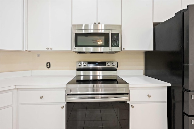 5215 New Brittany Ln, Zephyrhills, FL 33541 - kitchen featuring stainless steel appliances, light countertops, and white cabinetry