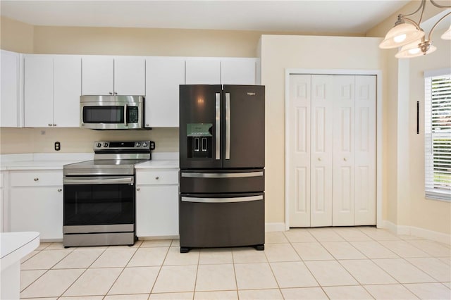 5215 New Brittany Ln, Zephyrhills, FL 33541 - kitchen with stainless steel appliances, light countertops, plenty of natural light, and white cabinets