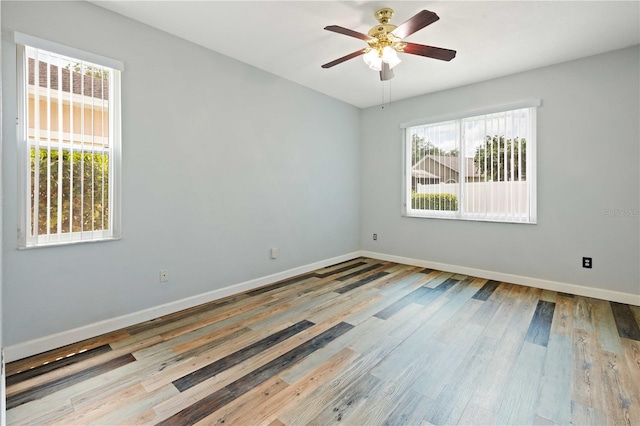 5215 New Brittany Ln, Zephyrhills, FL 33541 - unfurnished room with baseboards, ceiling fan, and wood finished floors