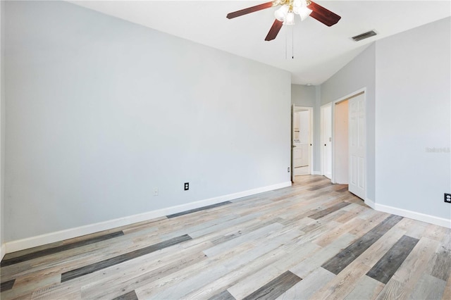 5215 New Brittany Ln, Zephyrhills, FL 33541 - spare room featuring light wood-type flooring, a ceiling fan, and baseboards