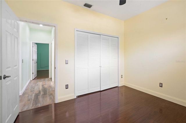 5215 New Brittany Ln, Zephyrhills, FL 33541 - unfurnished bedroom featuring wood finished floors, baseboards, a closet, and ceiling fan
