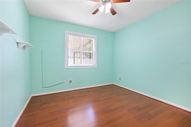 5215 New Brittany Ln, Zephyrhills, FL 33541 - spare room featuring wood finished floors, a ceiling fan, and baseboards