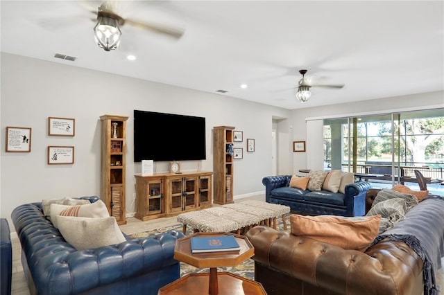 living room with ceiling fan and light hardwood / wood-style flooring