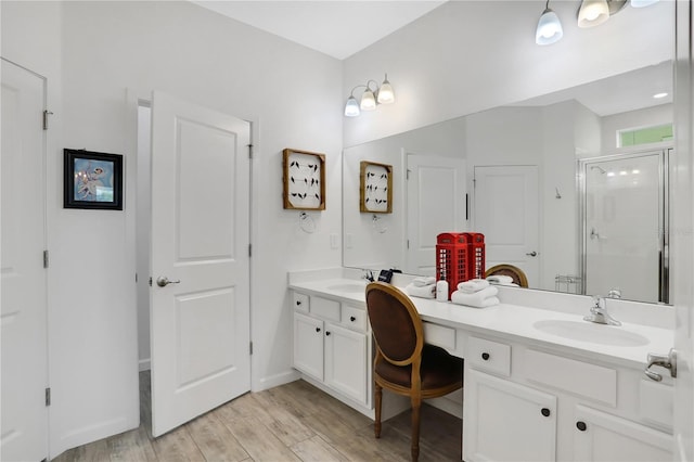 bathroom featuring wood-type flooring, vanity, and an enclosed shower