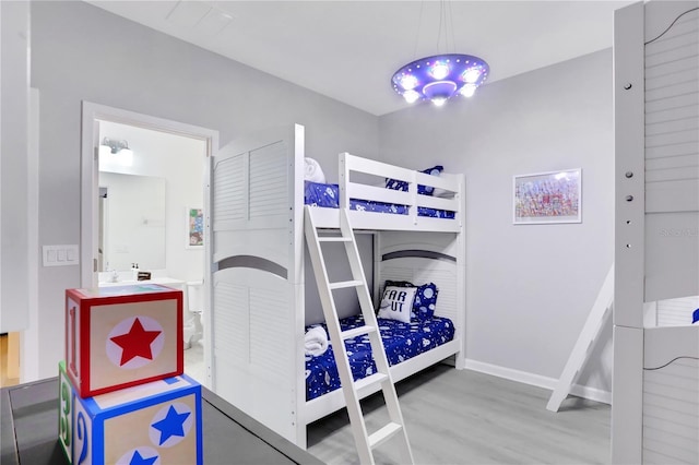 bedroom featuring hardwood / wood-style flooring and sink