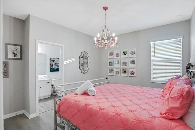 bedroom with hardwood / wood-style floors and a chandelier