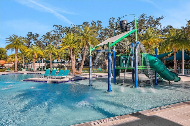 view of jungle gym featuring pool water feature and a community pool