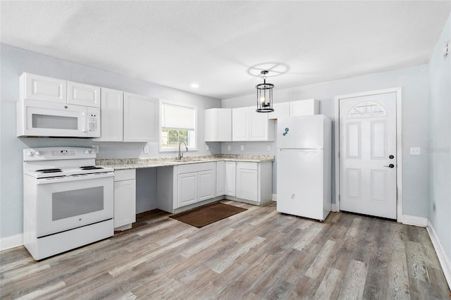 kitchen featuring white appliances, sink, pendant lighting, light hardwood / wood-style floors, and white cabinetry