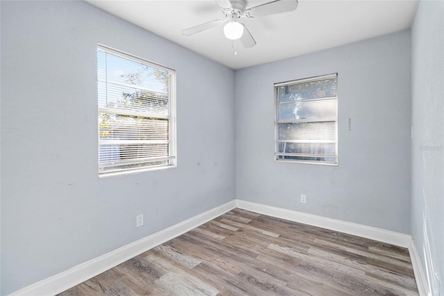 unfurnished room with ceiling fan and wood-type flooring