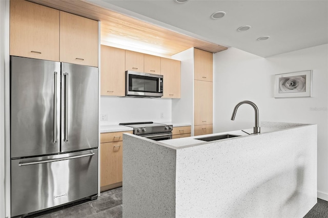 kitchen featuring light brown cabinetry, sink, and appliances with stainless steel finishes