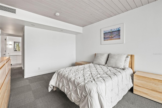 carpeted bedroom featuring ensuite bath