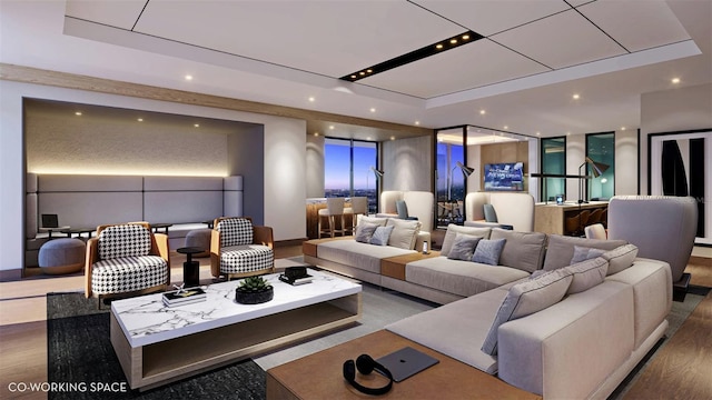 home theater room with hardwood / wood-style flooring and a raised ceiling