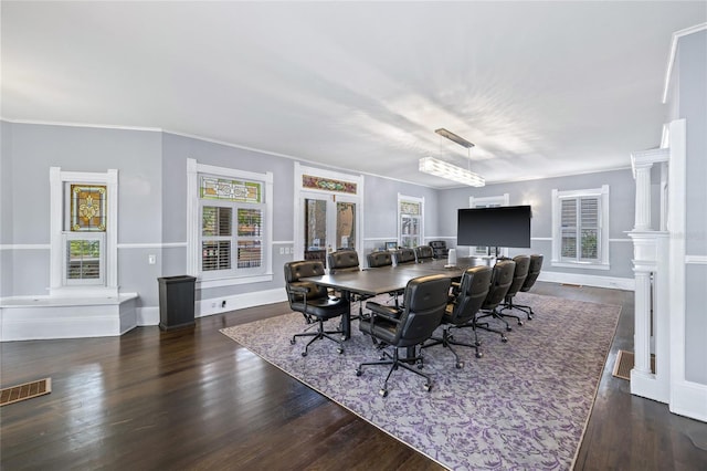 dining space with decorative columns and dark hardwood / wood-style floors