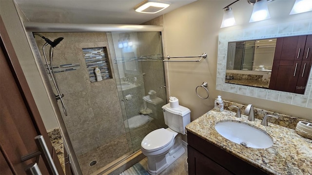 bathroom featuring vanity, toilet, and walk in shower