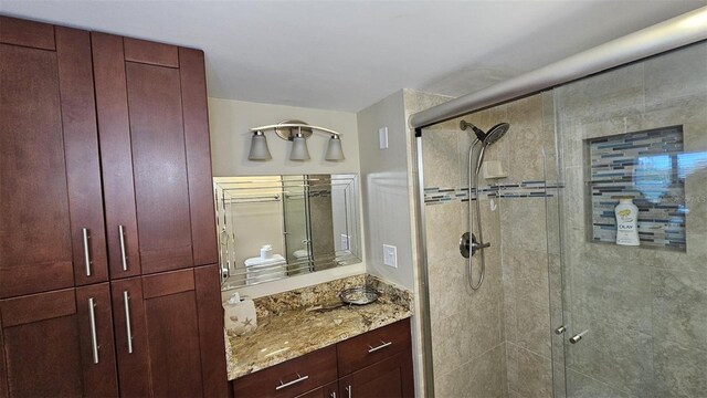 bathroom featuring vanity and an enclosed shower