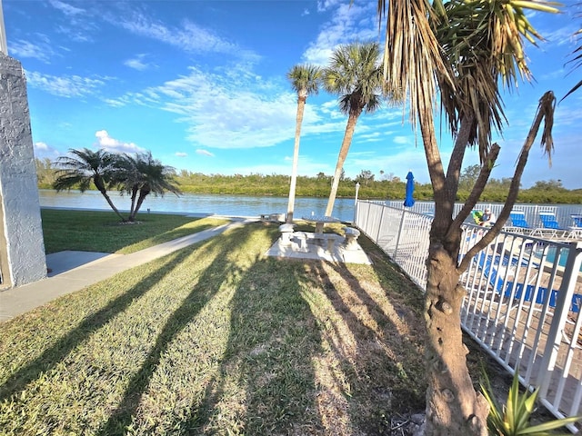 exterior space with a lawn and a water view