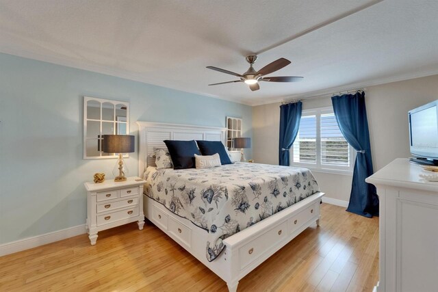 18325 Gulf Blvd Unit 407, Redington Shores, FL 33708 - bedroom featuring baseboards, light wood-style flooring, ornamental molding, and a ceiling fan