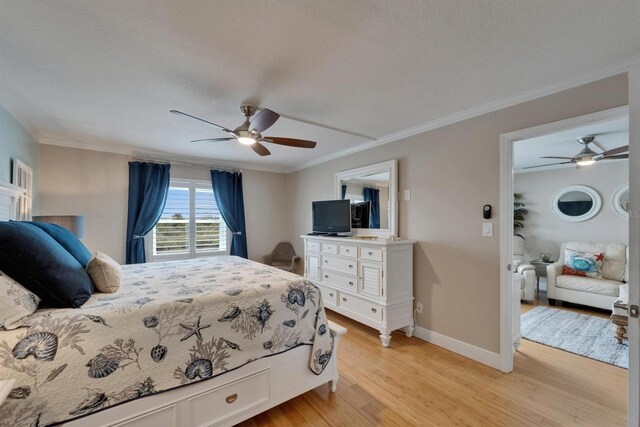 18325 Gulf Blvd Unit 407, Redington Shores, FL 33708 - bedroom with light wood-style floors, crown molding, baseboards, and a ceiling fan