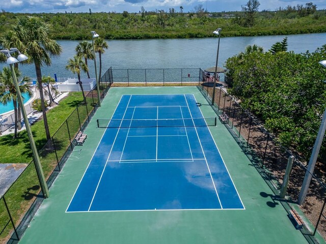18325 Gulf Blvd Unit 407, Redington Shores, FL 33708 - view of tennis court featuring fence and a water view