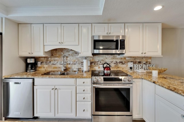 18325 Gulf Blvd Unit 407, Redington Shores, FL 33708 - kitchen with appliances with stainless steel finishes, a sink, crown molding, light stone counters, and tasteful backsplash