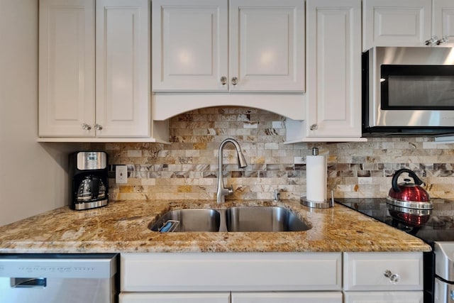 18325 Gulf Blvd Unit 407, Redington Shores, FL 33708 - kitchen with stainless steel microwave, a sink, dishwashing machine, and white cabinetry