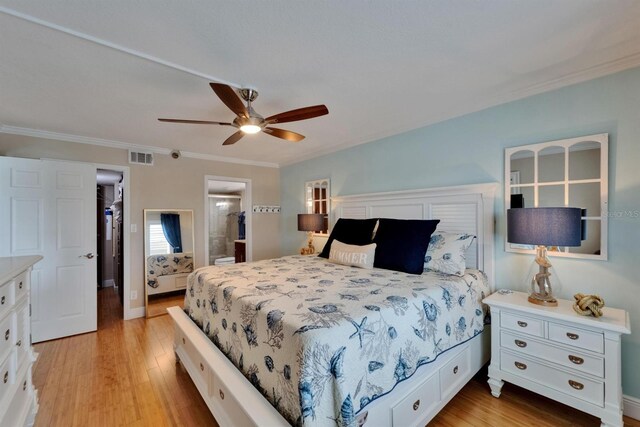 18325 Gulf Blvd Unit 407, Redington Shores, FL 33708 - bedroom featuring light wood-style flooring, crown molding, a ceiling fan, and connected bathroom
