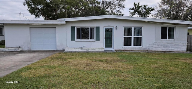 ranch-style home with a front lawn and a garage