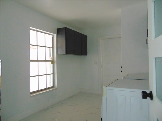 laundry area with cabinets and washing machine and clothes dryer