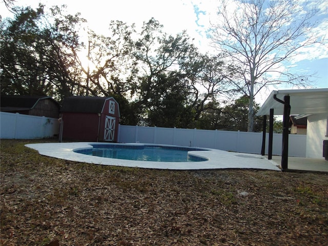 view of swimming pool with a patio and a storage unit