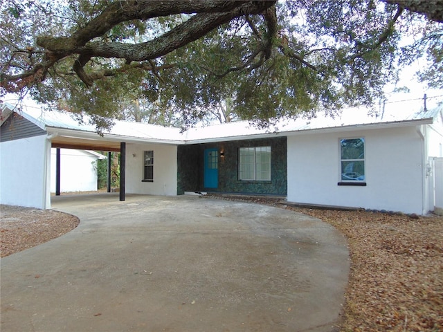 ranch-style home with a carport