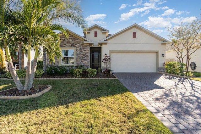 view of front of house featuring a garage and a front lawn