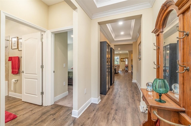 corridor featuring hardwood / wood-style flooring and ornamental molding