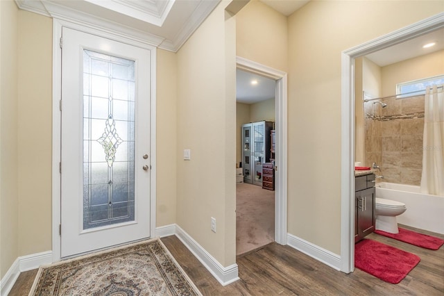 foyer featuring ornamental molding and dark wood-type flooring