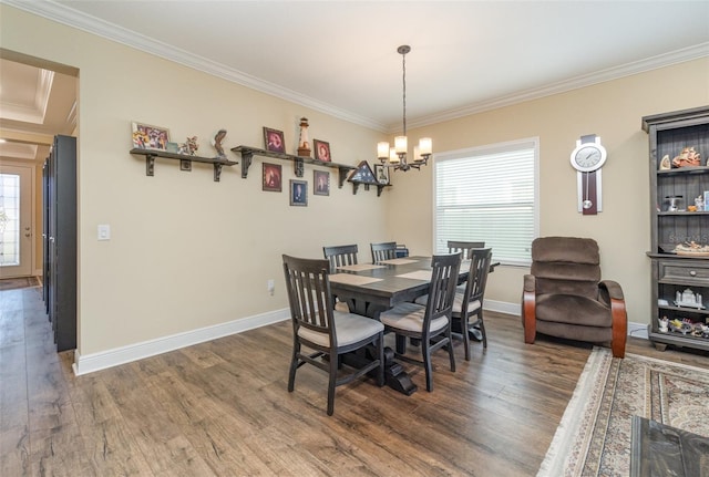 dining area featuring dark hardwood / wood-style flooring, plenty of natural light, and a notable chandelier