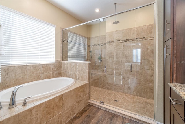 bathroom with hardwood / wood-style flooring, vanity, and independent shower and bath