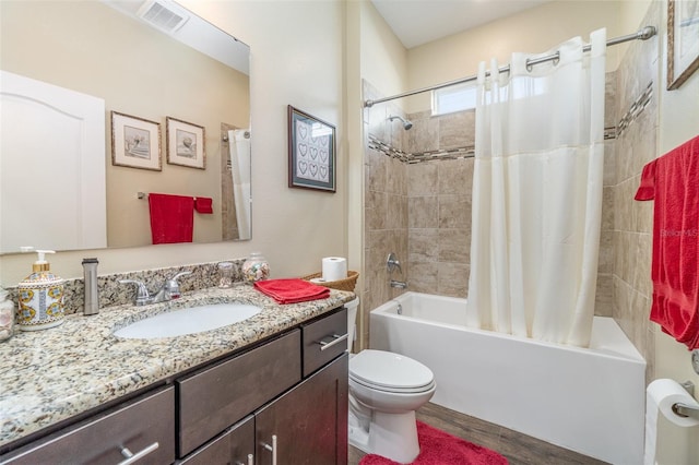 full bathroom featuring hardwood / wood-style floors, vanity, shower / bath combination with curtain, and toilet